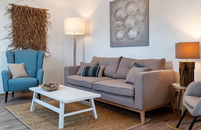 Exclusive, modern holiday apartment with a beach chair in the garden