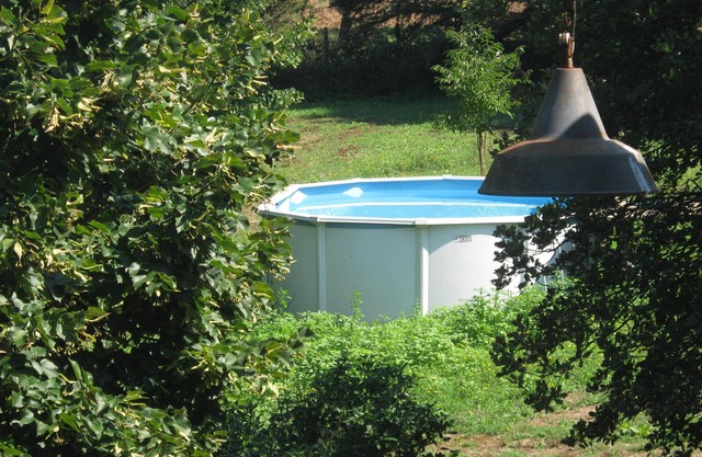 FARMHOUSE SURROUNDED BY GREENERY AND CULTIVATED FIELDS OF VEGETABLES