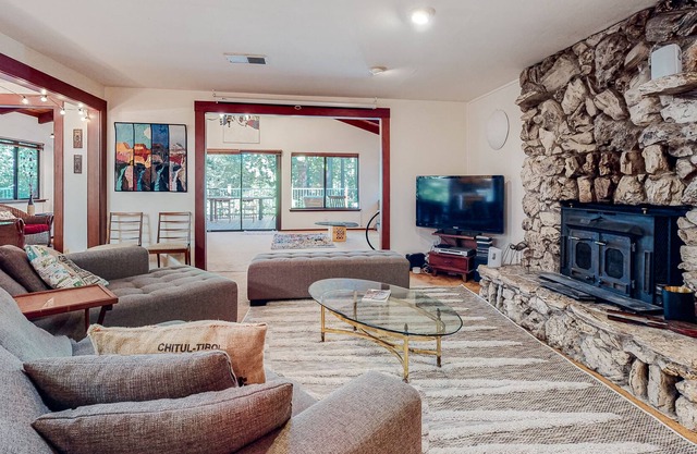 Forested home near the river with a hot tub, deck, playground, & washer/dryer