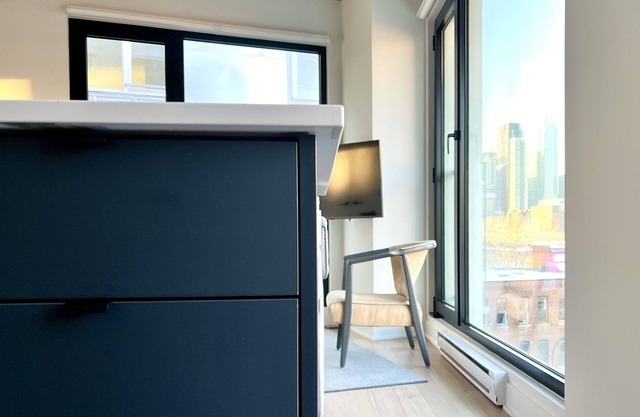 French-scandi canal living: EV/bike parking, gym, pools, rooftop, $133 USD/night