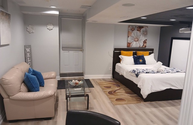 furnished basement studio, with1 queen bed, a kitchenette, and 1 bathroom.