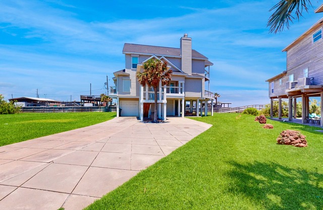 Galveston home with open floor, balcony, patio and water views