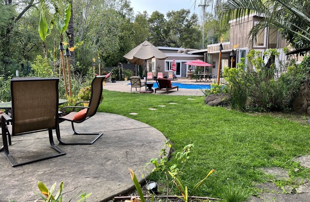 Gated, mid-century modern home feels like Hawaii -designed for entertaining/fun.