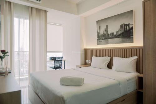 Good and Homey Studio at Pacific Garden Alam Sutera Apartment By Travelio