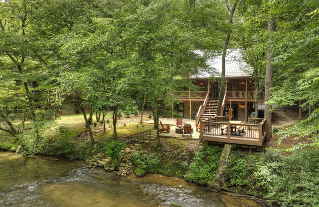 Gorgeous river front cabin rental with tons of outdoor space, hot tub and firepit