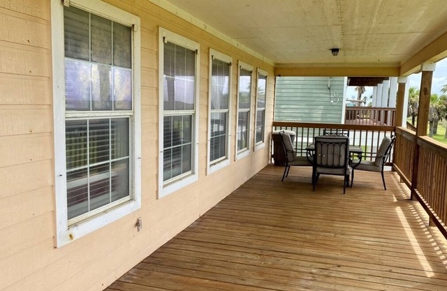 Great house with big porch overlooking beach
