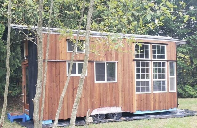 High end tiny home with tons of light, exposes serene views of mature forests.