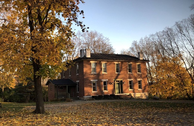 Historic home (circa 1834) on 18 acre country setting with 2 story balcony