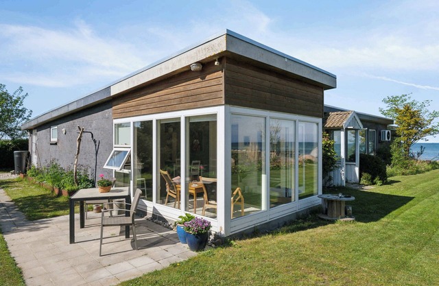 Holiday home with private beach and sea view