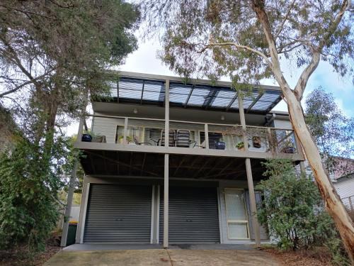 Holiday house among native trees overlooking wetlands