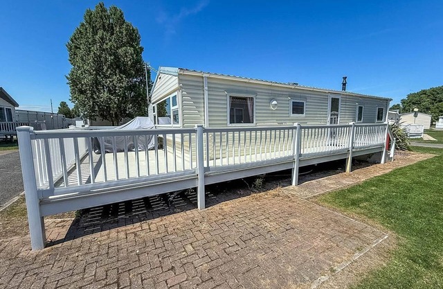 Homely 8 berth caravan with decking to relax on at Naze Marine, ref 17009WC