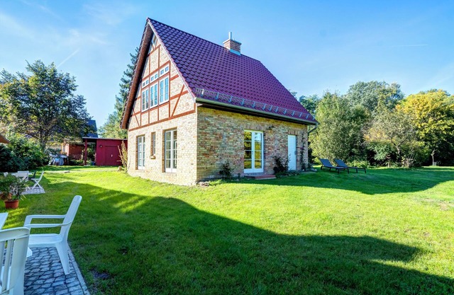 House in the middle of the garden by the swan pond