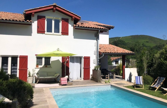 House with swimming pool between sea and mountains