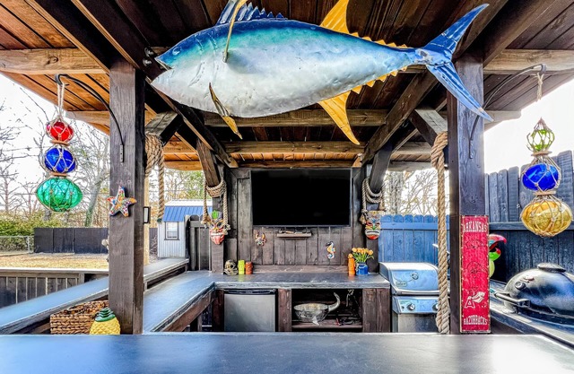 Ideally located home with enclosed yard, tiki bar, grill, smoker, & smart TVs