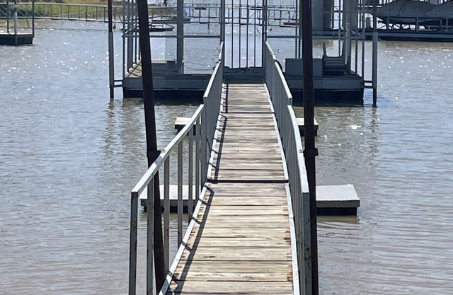 Lake front retreat, covered boat dock, large deck , fenced play area, RV parking