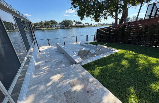 Lakefront 5-bedroom, 4 bathroom home in tranquil Miami Lakes with Fitness room.