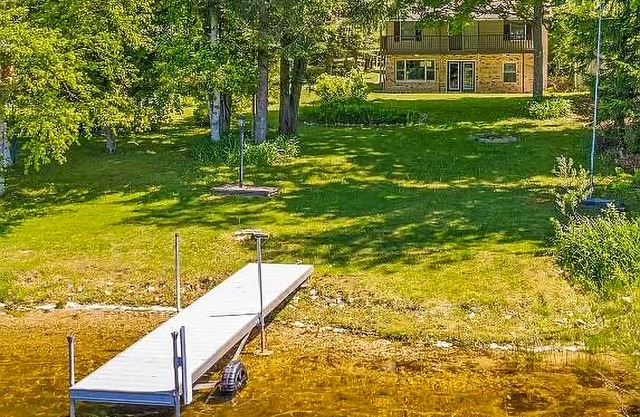 Lakefront home with large yard, dock, gas grill, WIFI near golf & ATV trails!