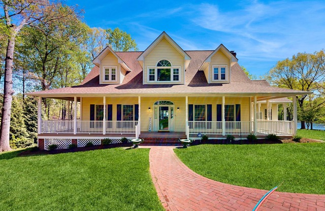 Lakefront home with private dock, kayaks, beach, badminton, firepit, & deck
