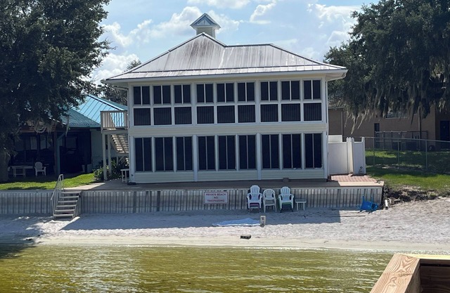Lakefront home with white sand beach and private boat dock on Crooked Lake.