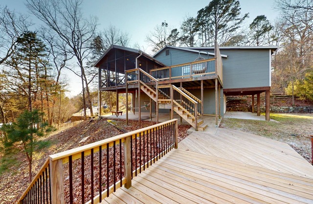 Lakefront retreat with screened sunroom, wood stove, multiple decks, & AC
