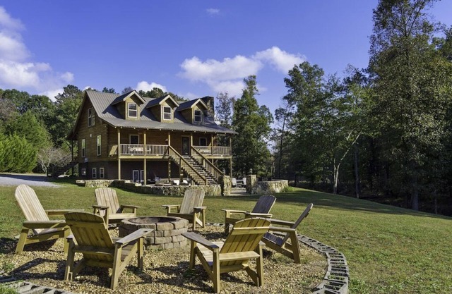 Large authentic 3-story log cabin adjacent to lake. Up to 14 guests.