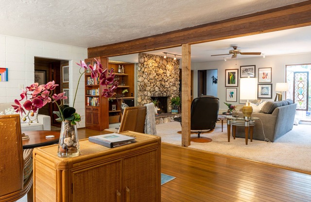 Large living area, tropical backyard with swimming pool & covered back porch