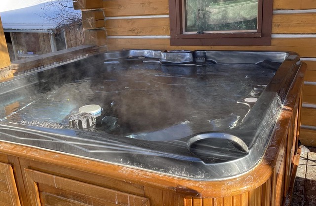 Log cabin with large deck and 6 person hot tub