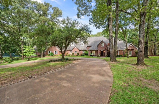 Luxury home on 27 wooded acres with two private lakes in Athens, Texas.