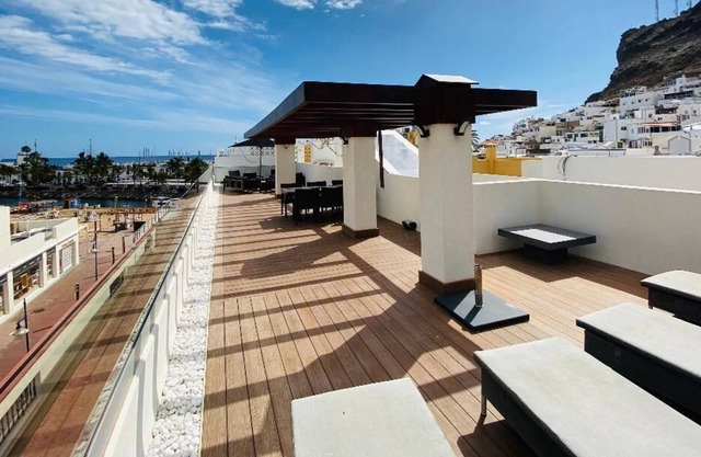 Luxury penthouse in town center Puerto Mogan with ocean and beach views.