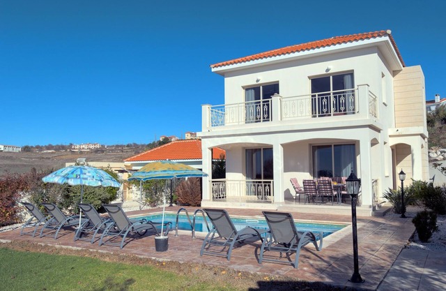 Luxury villa on mountainside with sea views and private pool.