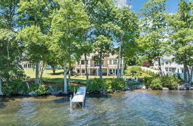Modern Lake Opechee Home features Sandy Perched Beach and Dock
