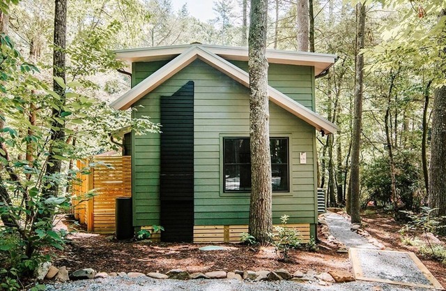 Serene riverfront cabin in North GA with a hot tub, fire pit, porch swing & movie loft.