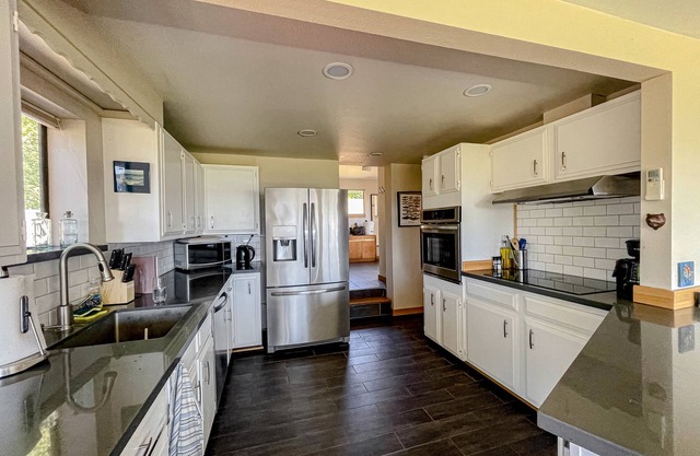 Ocean view home with incredible setting & deck - walk to the beach, near town