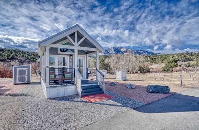 Park Model Cabin - Twin Loft - One queen bed in the private bedroom, with two twin beds in the open loft.