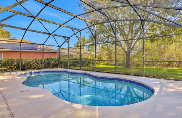 Peaceful home with an enclosed patio, pool, grill, washer/dryer, & AC