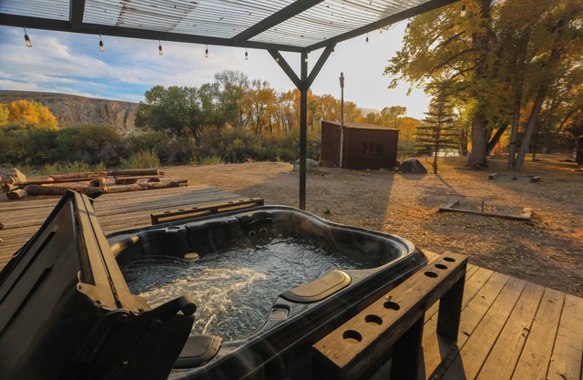 Escape to a Deluxe Queen Room with Tranquil River Views and Breathtaking Mountain Backdrop.