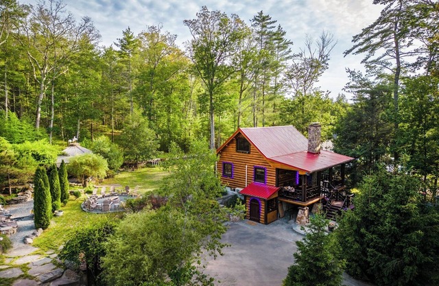 Private log cabin nestled at the base of a secluded wooded area