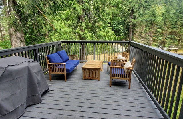 Riverfront cottage with stairs to the river, firepit, and forested retreat.