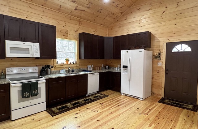 Riverfront Luxury Log Cabin with outside fire pit and deck overlooking the water