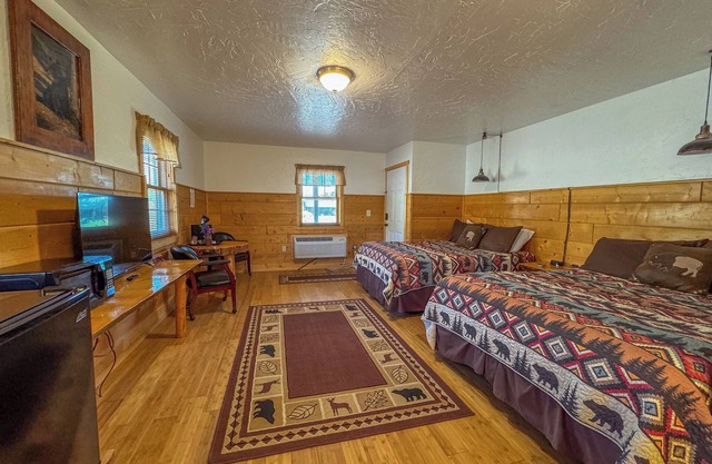 Experience the Tranquility of a Premium Double Queen Room with Direct Riverfront Access and Spectacular Mountain Scenery!