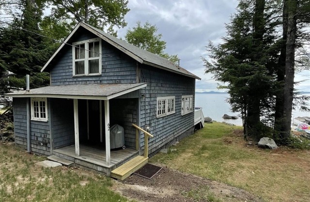 Rustic shorefront cottage with a small sandy beach