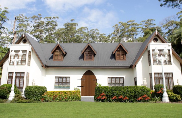 Scottish Manor nestled in lush tropical Rainforest next to bubbling stream.