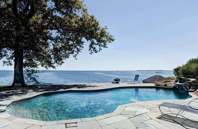 Seas the Day at this water front home with sweeping views of the Bay