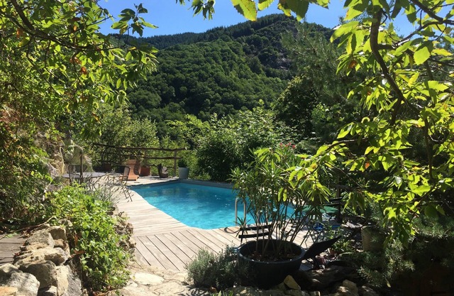 Secluded stone house on the banks of a stream with swimming pool