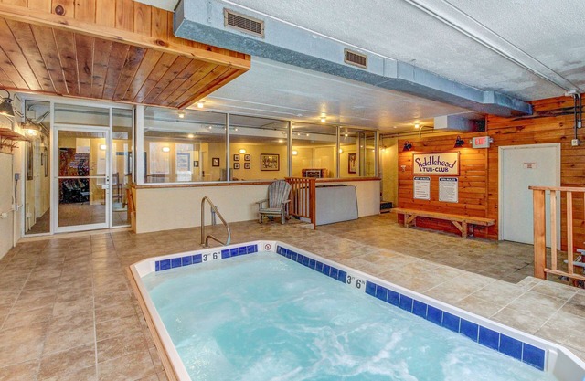 Ski-in/out condo with pool, hot tub, game room, mountain view, & fireplace