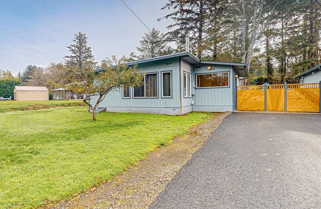 Spacious coastal property with separate living quarters, wood stove, & grill