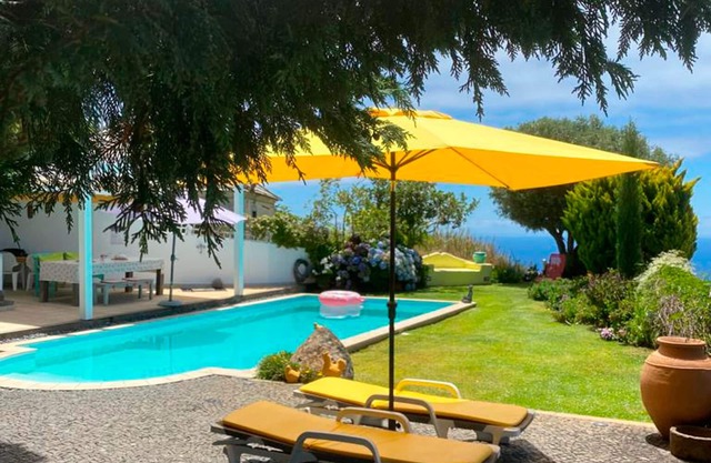 Villa típica en la isla de Madeira con piscina y vistas al mar.