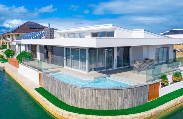 Spectacular 270° views of canal, private pool & jetty, king bed & an office!