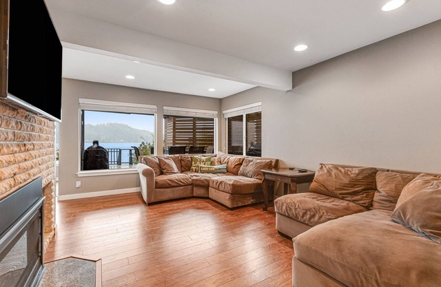 Sprawling lakefront property with kayaks, large deck, game table, & fireplace
