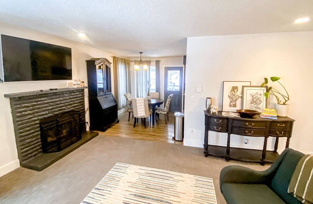 Striking home with fireplace, kitchen, gas grill, patio, deck, & washer/dryer